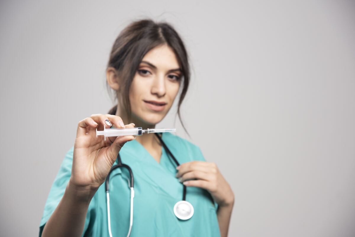 female-doctor-with-stethoscope-holding-syringe-1200x801.jpg